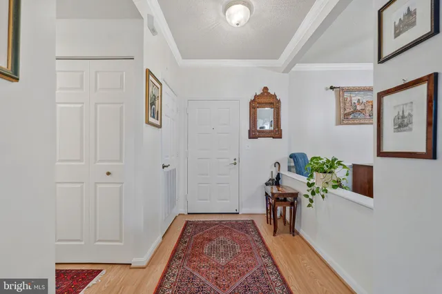a hallway with table and couch