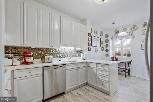 a kitchen with cabinets appliances and a sink