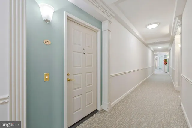 a view of hallway with stainless steel appliances and cabinets