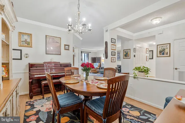 a view of a dining room with furniture and chandelier