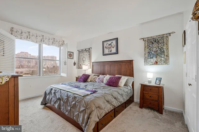a bedroom with a bed and glass window
