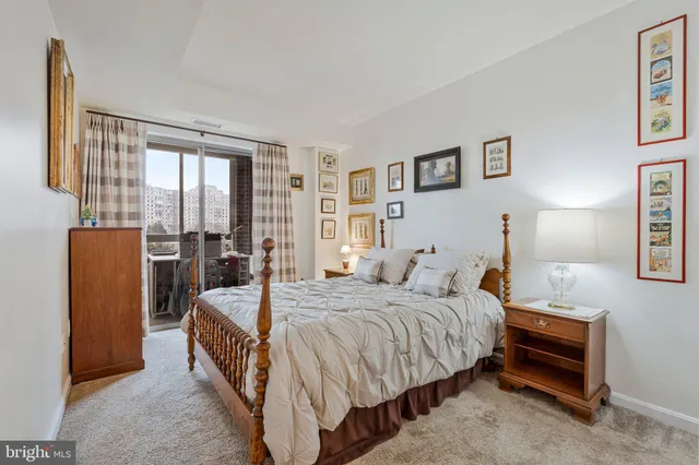 a bedroom with a bed and a night stand