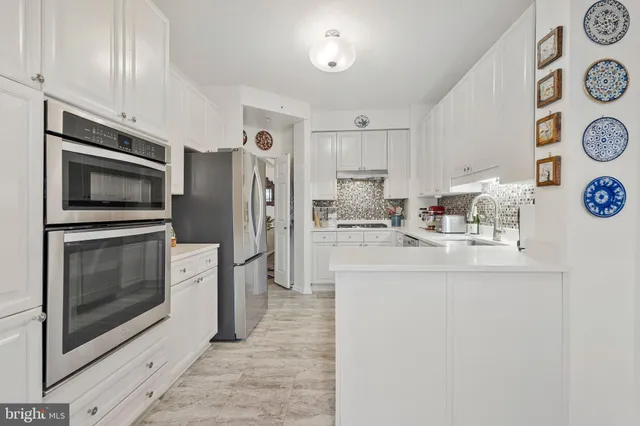a kitchen with stainless steel appliances a stove a microwave and a refrigerator