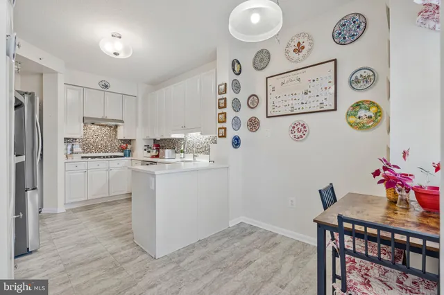 a kitchen with granite countertop a refrigerator and a stove