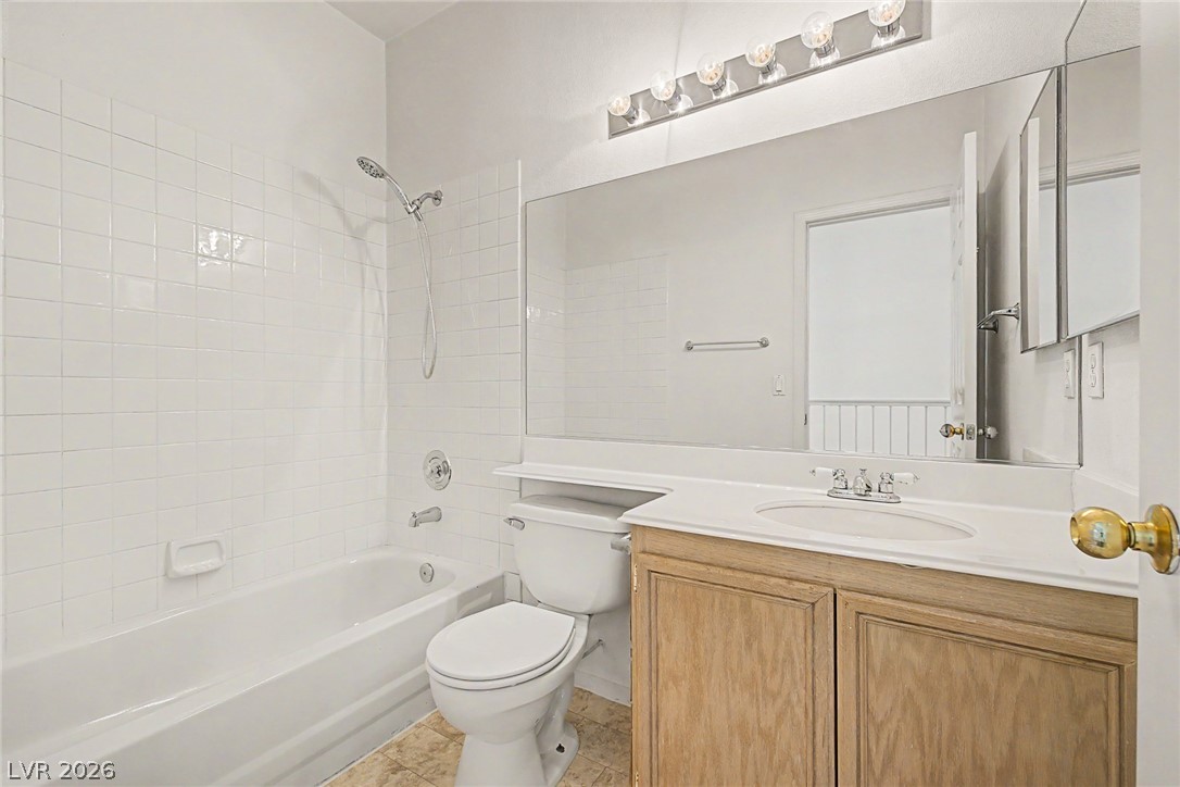 2223 Ramsgate Drive Henderson, NV 89074 - Photo 20 of 32 A well-appointed bathroom features a practical vanity and a classic tub-shower combination.