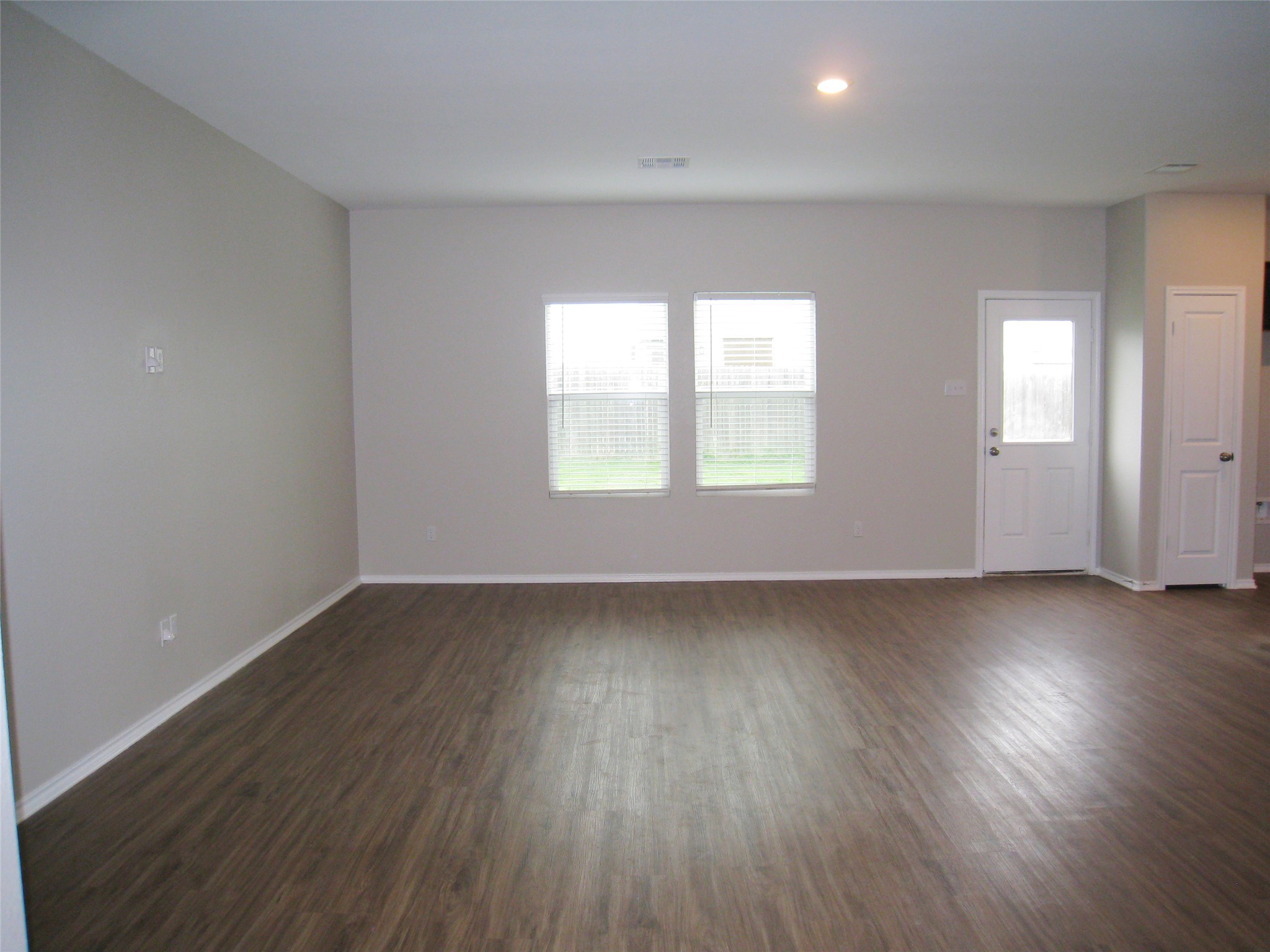 229 Geode Glen Maxwell, TX 78656 - Photo 4 of 19 A spacious, naturally illuminated room boasts elegant wood flooring and clean, minimalist design.