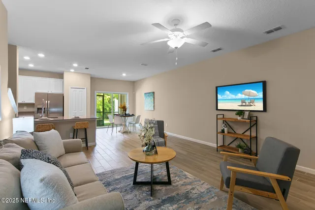 a living room with furniture a rug and a flat screen tv