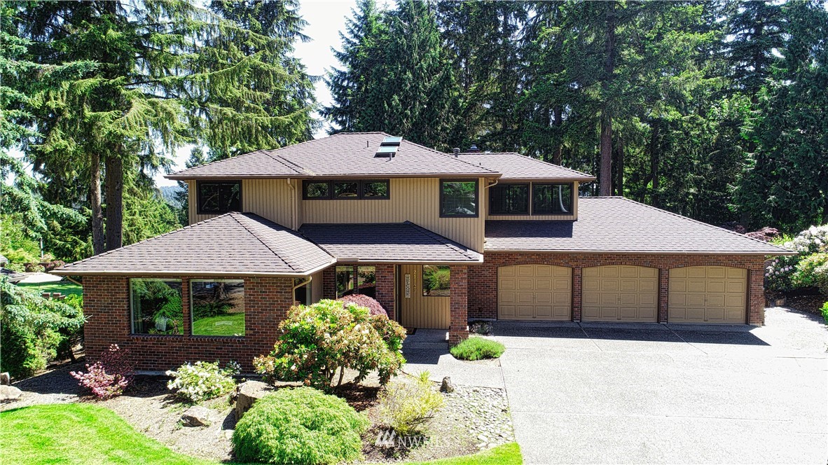 21129 49th Avenue Southeast Bothell, WA 98021 - Photo 1 of 40 a front view of a house with a yard and garage