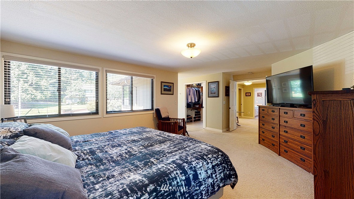 21129 49th Avenue Southeast Bothell, WA 98021 - Photo 22 of 40 a bedroom with a bed and a flat screen television