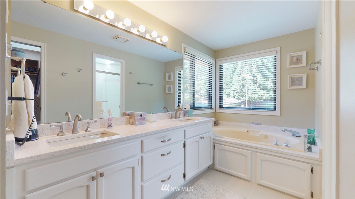 21129 49th Avenue Southeast Bothell, WA 98021 - Photo 23 of 40 a bathroom with double vanity sink a bathtub and a window