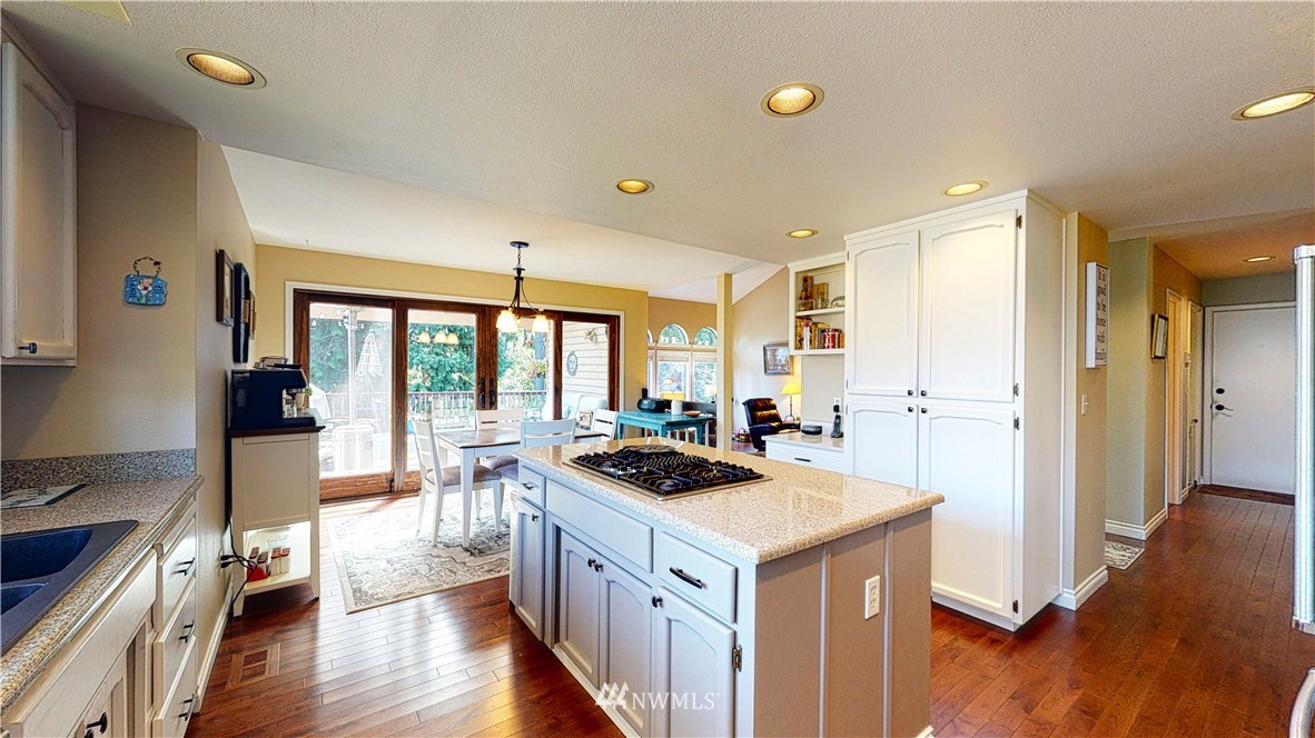 21129 49th Avenue Southeast Bothell, WA 98021 - Photo 7 of 40 a kitchen that has a lot of cabinets a sink and wooden floor