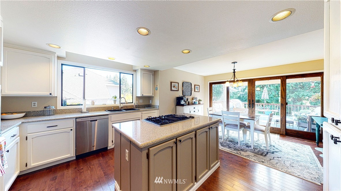 21129 49th Avenue Southeast Bothell, WA 98021 - Photo 8 of 40 a kitchen with a sink stove and wooden cabinets
