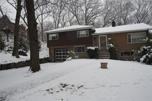 114 Leland Road Boston, MA 02467 - Photo 19 of 22 a view of a house with a yard covered in snow