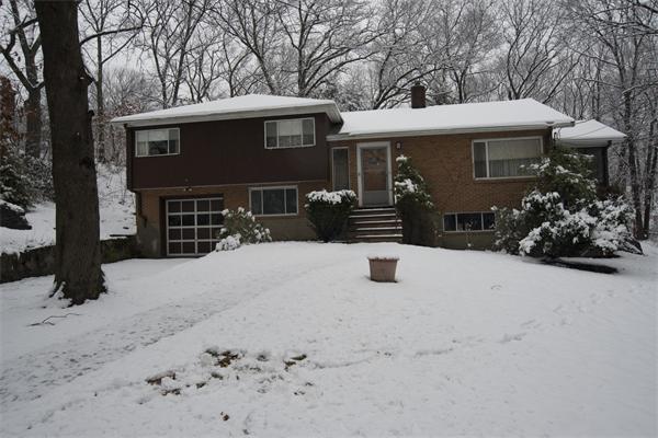 114 Leland Road Boston, MA 02467 - Photo 2 of 22 a front view of a house with a yard covered in snow