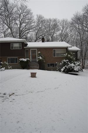 114 Leland Road Boston, MA 02467 - Photo 21 of 22 front view of house with a yard covered in snow