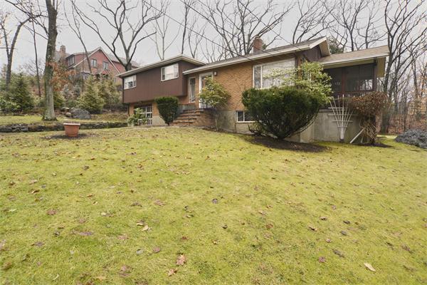 114 Leland Road Boston, MA 02467 - Photo 5 of 22 a view of a yard with plants and a tree