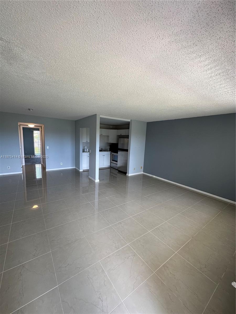 37 Brighton A, Unit 37 Boca Raton, FL 33434 - Photo 13 of 30 a view of empty room with a fireplace