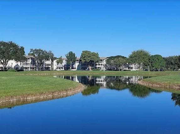 37 Brighton A, Unit 37 Boca Raton, FL 33434 - Photo 17 of 30 a view of a lake with houses in the background