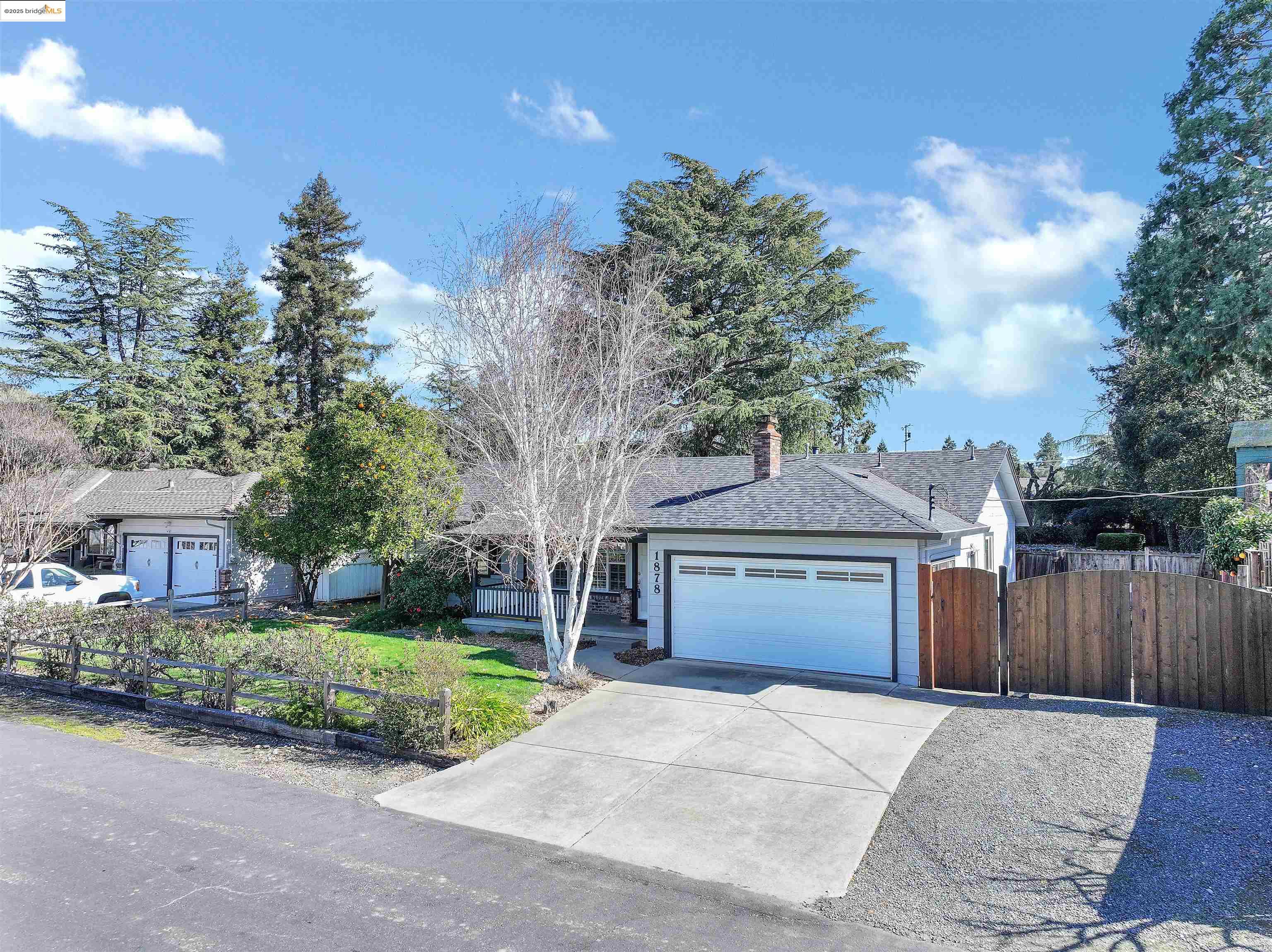 1878 Andrews Drive Concord, CA 94521 - Photo 1 of 28 a front view of a house with a garden and trees