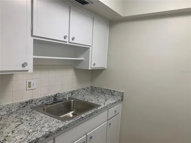 a kitchen with a sink and cabinets