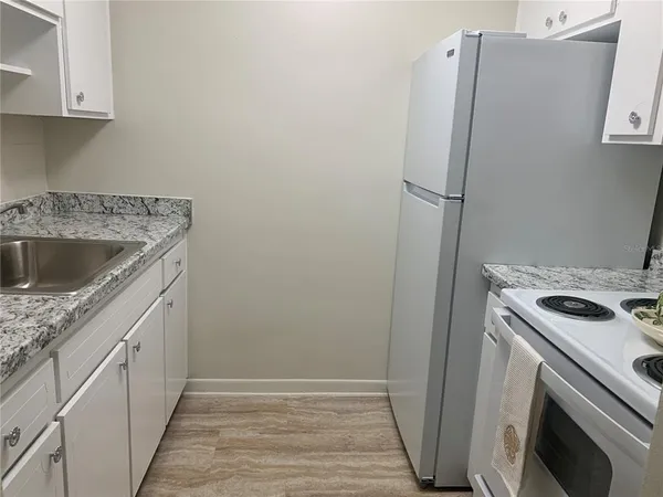 a kitchen with a sink and a refrigerator