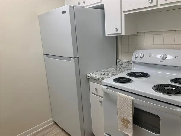 a kitchen with refrigerator and stove