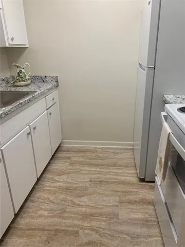 a kitchen with a sink a refrigerator and washer