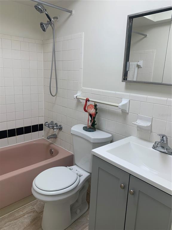 1257 Drew Street, Unit 15 Clearwater, FL 33755 - Photo 19 of 30 a bathroom with a sink a toilet and shower