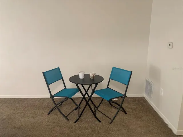 a view of a room with furniture and wooden floor