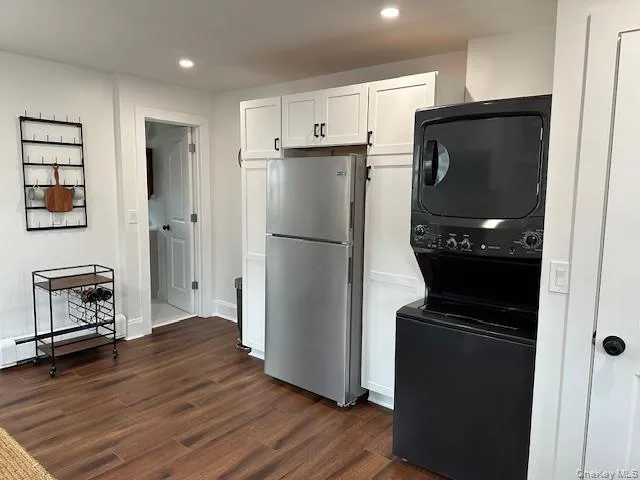 a kitchen with a refrigerator and a stove top oven
