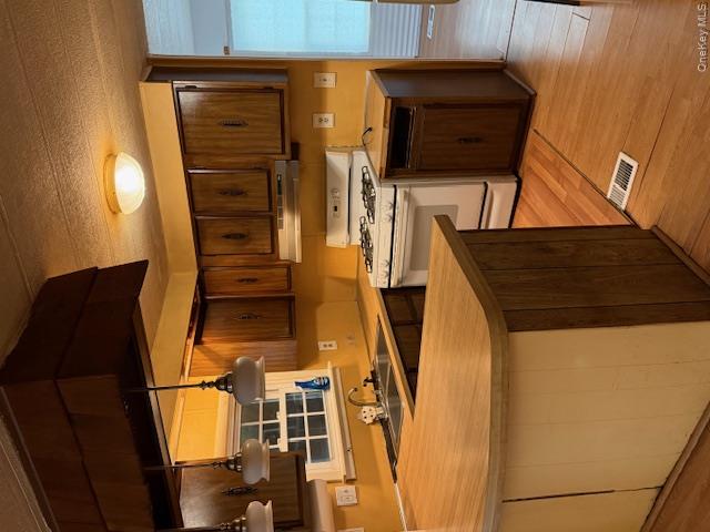 1661 Old Country Road, Unit 415 Riverhead, NY 11901 - Photo 4 of 10 a kitchen with stainless steel appliances kitchen island granite countertop a sink and a stove