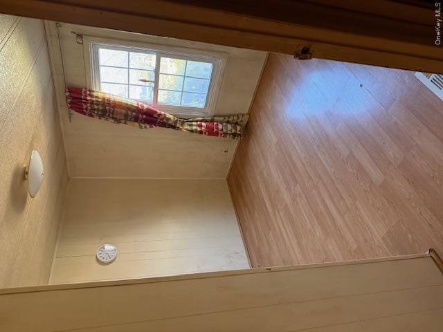 1661 Old Country Road, Unit 415 Riverhead, NY 11901 - Photo 6 of 10 an empty room with wooden floor and windows