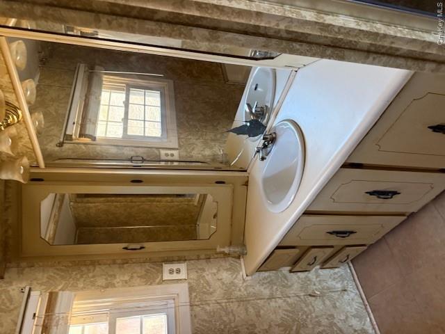 1661 Old Country Road, Unit 415 Riverhead, NY 11901 - Photo 7 of 10 a bathroom with a sink and a mirror