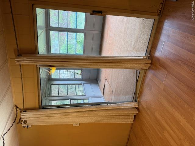 1661 Old Country Road, Unit 415 Riverhead, NY 11901 - Photo 10 of 10 an empty room with wooden floor and windows