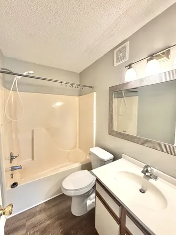 a bathroom with a sink a toilet and a bathtub