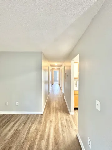 a view of a room with wooden floor and windows