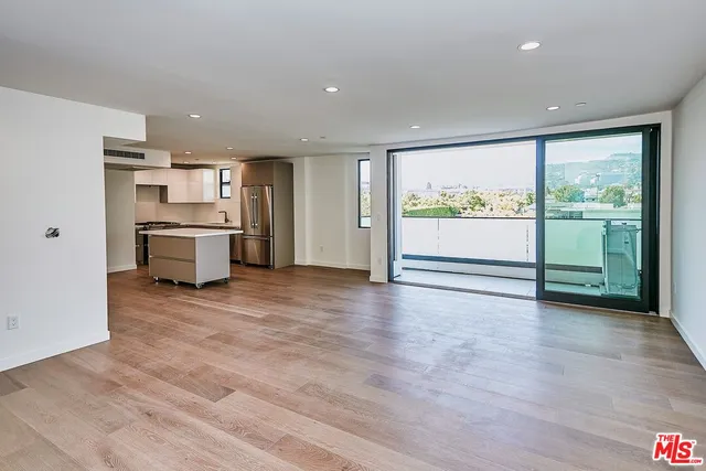 a view of a kitchen with a sink and a large window