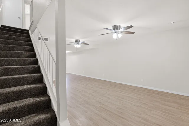 a view of entryway and hall with wooden floor