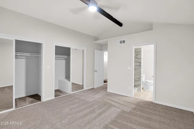 a view of a big room with closet and windows