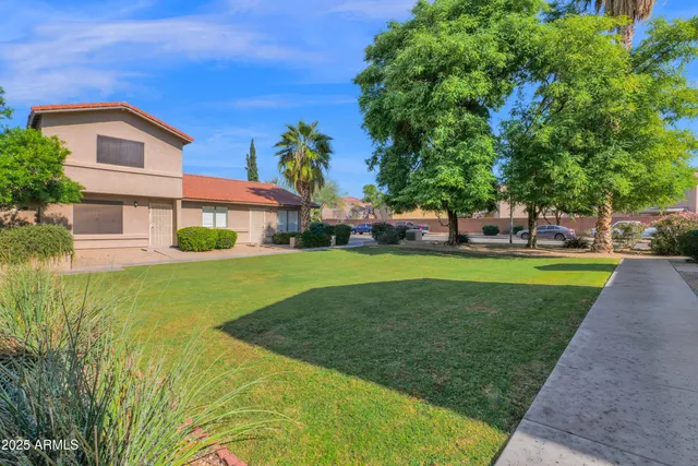 a front view of house with yard and green space
