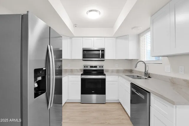 a kitchen with a sink and stainless steel appliances