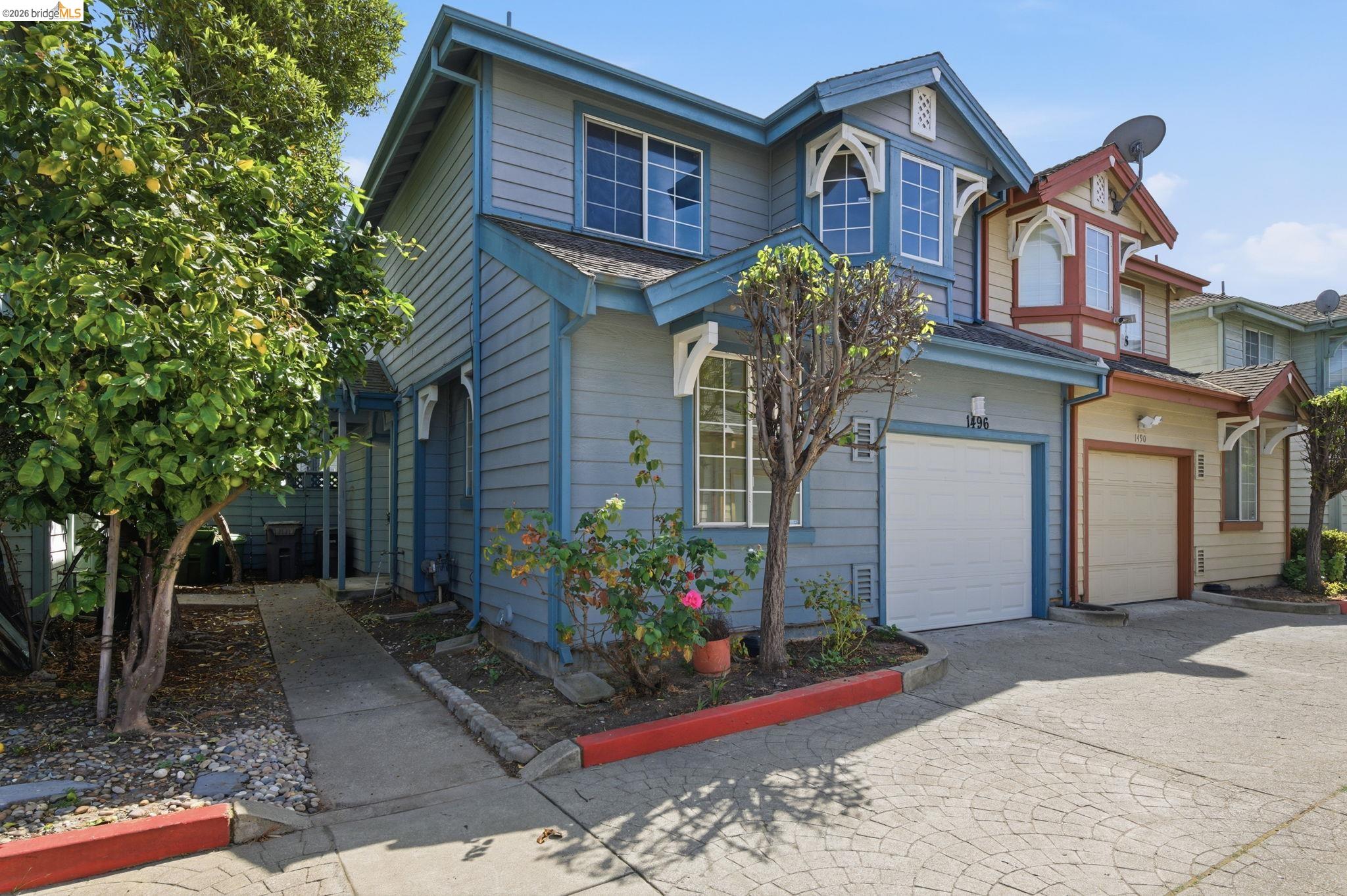 1496 Adeline Street Oakland, CA 94607 - Photo 1 of 17 a front view of a house with a yard
