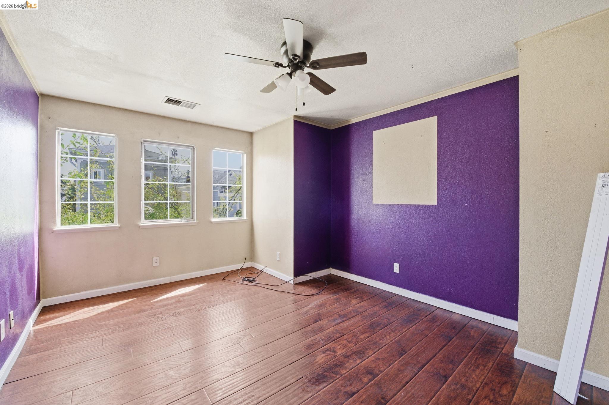 1496 Adeline Street Oakland, CA 94607 - Photo 11 of 17 a view of an empty room with wooden floor and a window