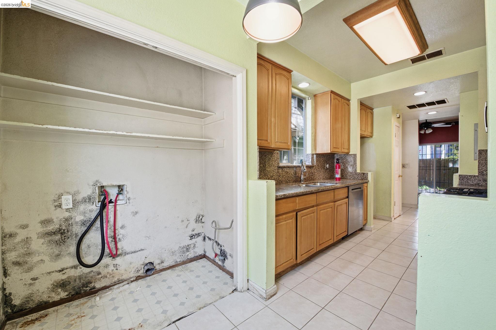 1496 Adeline Street Oakland, CA 94607 - Photo 6 of 17 a kitchen with a sink and a refrigerator