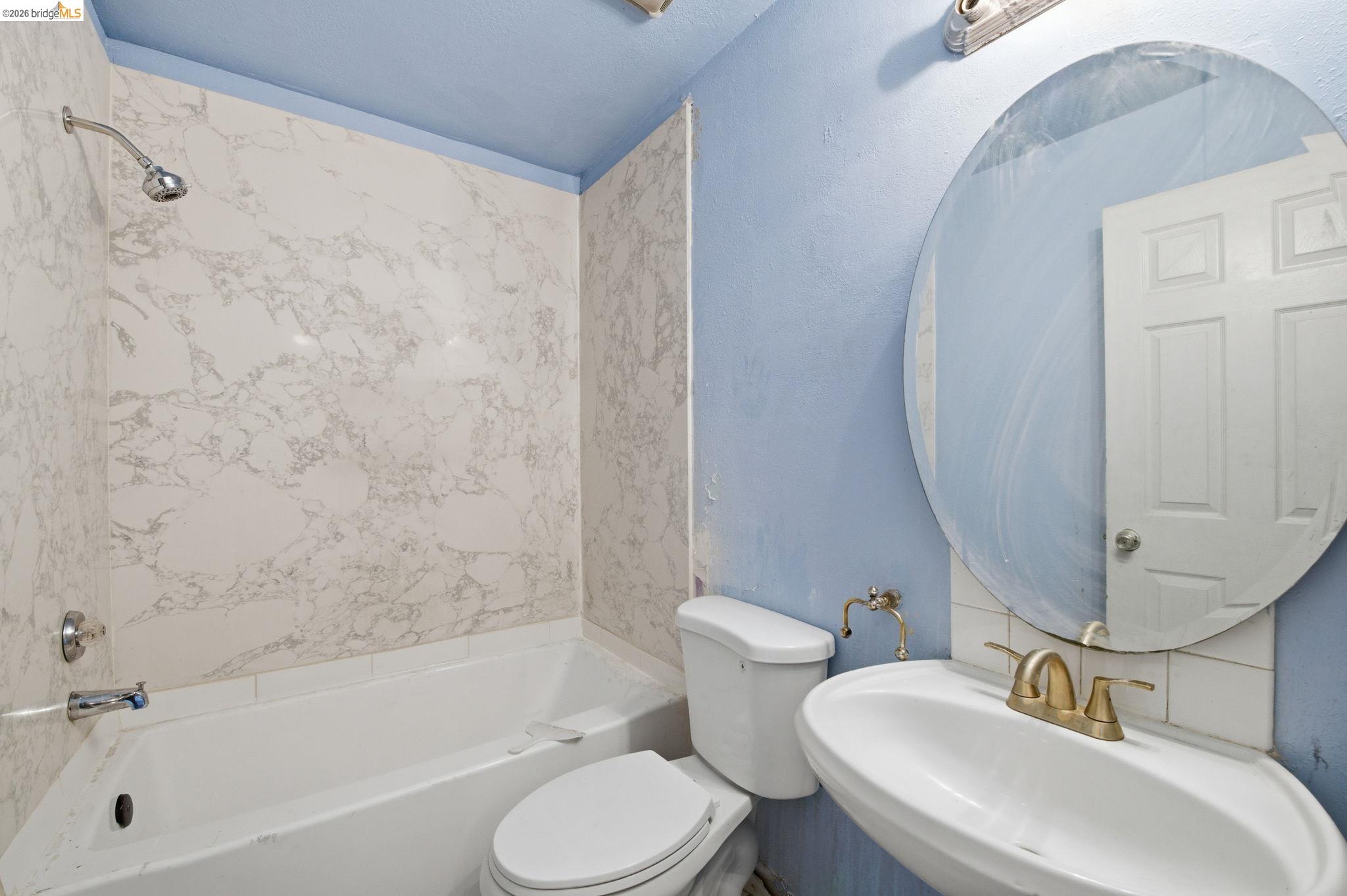1496 Adeline Street Oakland, CA 94607 - Photo 7 of 17 a bathroom with a sink toilet and bathtub