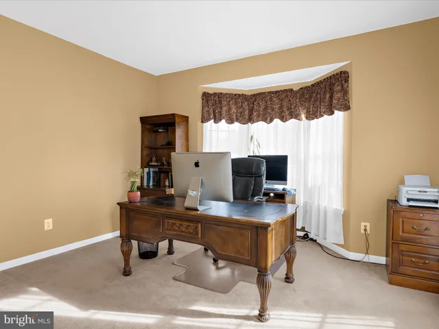 a view of a dining room with furniture and window