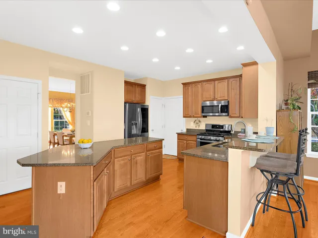 a kitchen with granite countertop a sink and cabinets
