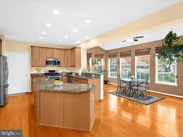 a kitchen with granite countertop a sink and cabinets