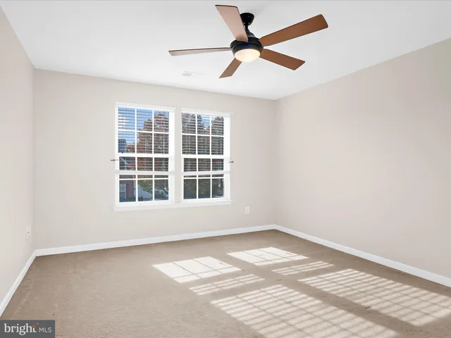 a view of a small space with wooden floor and a window