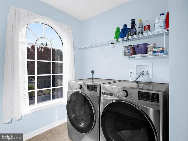 a view of a small space with wooden floor and a window